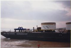 Barge carrying 'Janice' run ashore in preparation for unloading.